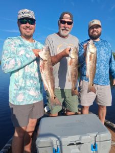 Three redfish caught on Flagler Beach fishing charter